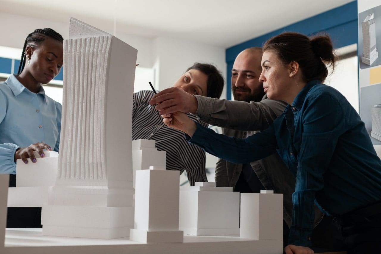 Architects and builders reviewing a building model